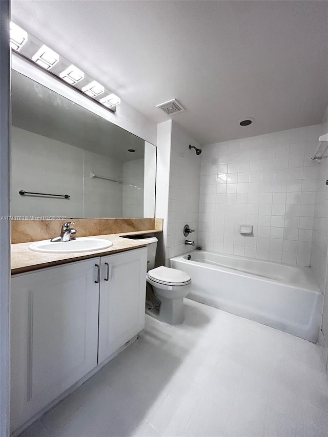 full bathroom with vanity, toilet, and tiled shower / bath