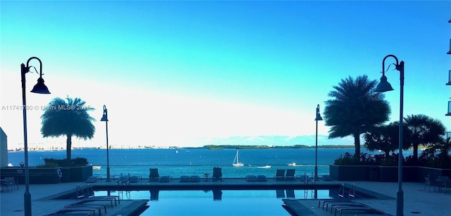 view of pool featuring a water view