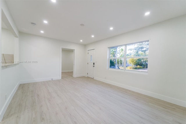 unfurnished room with light hardwood / wood-style floors