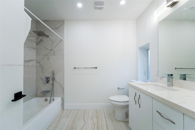 full bathroom featuring tiled shower / bath combo, vanity, and toilet