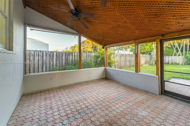 unfurnished sunroom with vaulted ceiling and ceiling fan