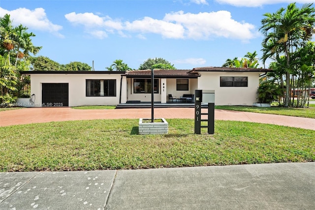 view of front of property featuring a garage and a front lawn