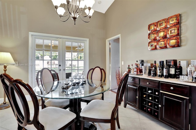 tiled dining area featuring a notable chandelier and french doors