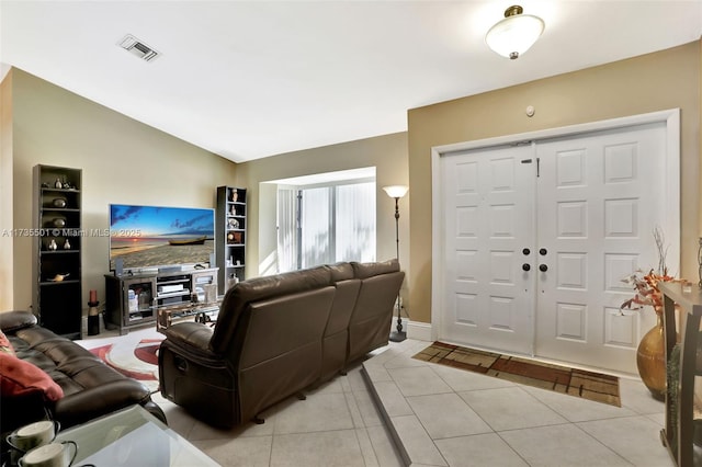 living room featuring light tile patterned flooring and vaulted ceiling