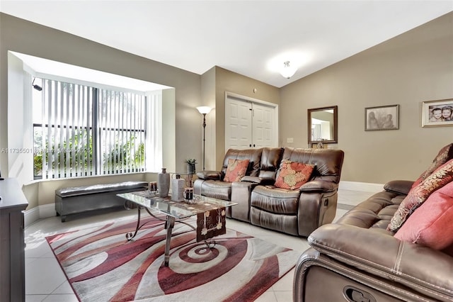 living room with vaulted ceiling and light tile patterned floors