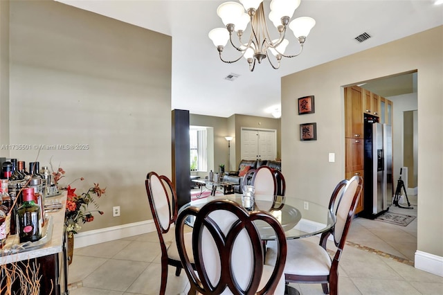 tiled dining room featuring a notable chandelier