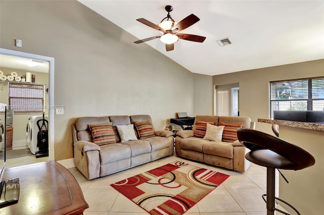 living room featuring ceiling fan, separate washer and dryer, high vaulted ceiling, and light tile patterned floors