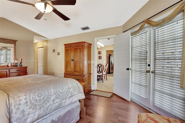 bedroom with lofted ceiling, light hardwood / wood-style floors, a closet, and ceiling fan