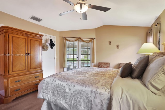 bedroom featuring lofted ceiling, ceiling fan, access to exterior, dark hardwood / wood-style floors, and french doors