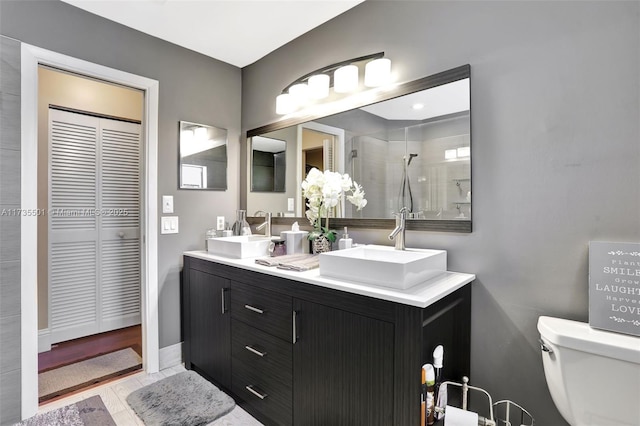 bathroom featuring vanity, a shower, and toilet