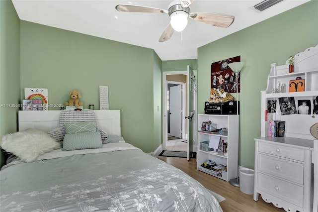 bedroom with ceiling fan and light hardwood / wood-style floors