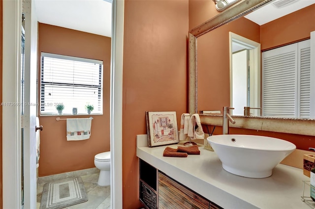 bathroom featuring vanity and toilet