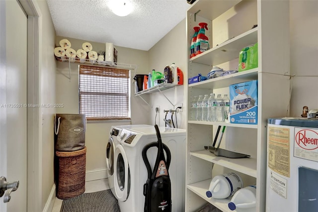 laundry area with independent washer and dryer, water heater, and a textured ceiling