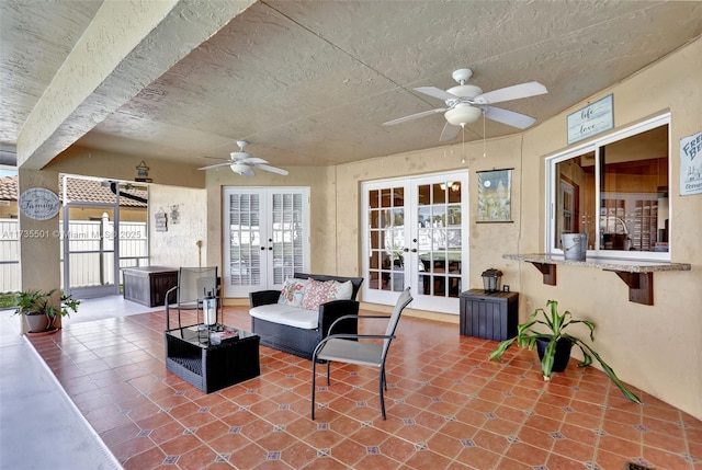 view of patio with outdoor lounge area, french doors, and ceiling fan