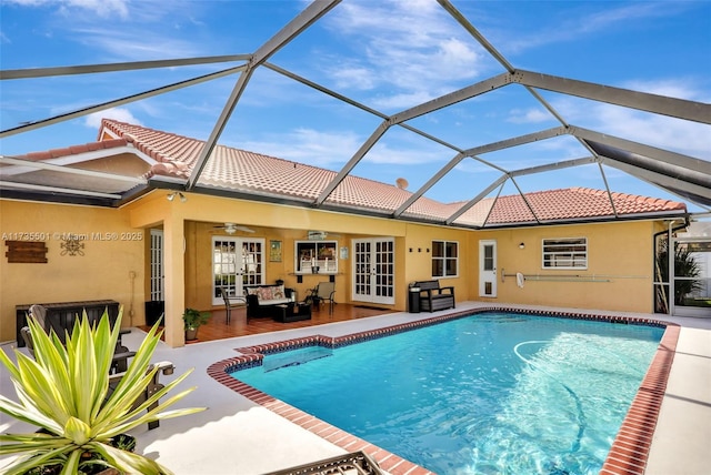 view of pool with french doors, an outdoor hangout area, ceiling fan, glass enclosure, and a patio area