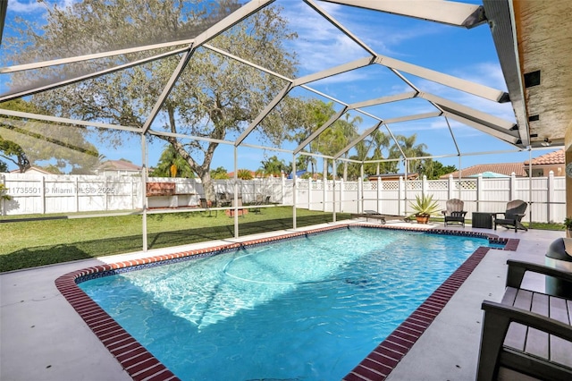 view of pool featuring a patio, a yard, and glass enclosure