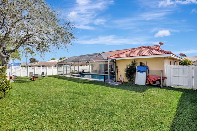 view of yard featuring a fenced in pool and glass enclosure