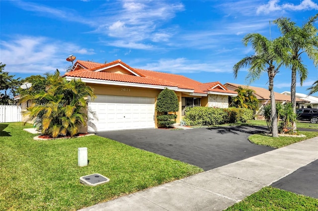 view of front facade with a garage and a front yard