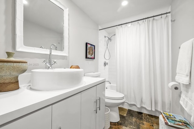 full bathroom with vanity, shower / bath combo, and toilet