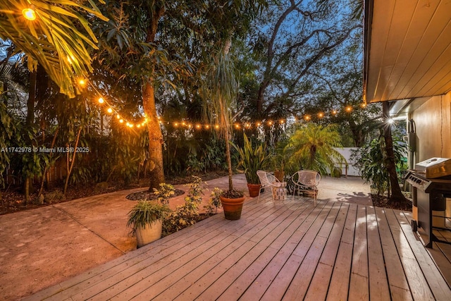 wooden terrace with a patio area