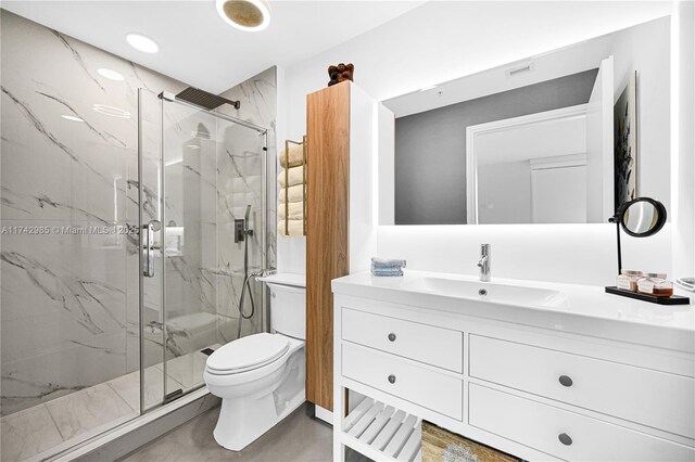 bathroom with toilet, vanity, and an enclosed shower