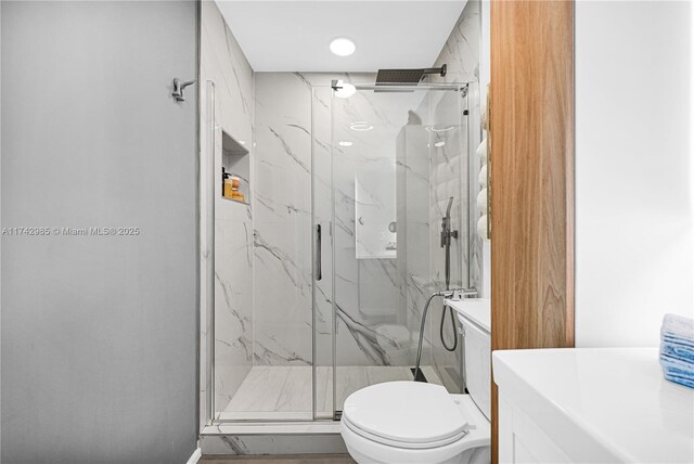 bathroom with vanity, toilet, and walk in shower