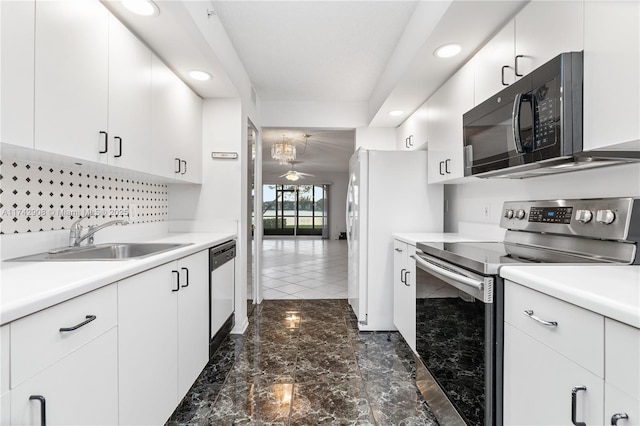 kitchen with stainless steel appliances, sink, white cabinets, and ceiling fan