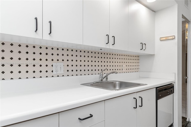 kitchen featuring sink, white cabinets, and dishwasher