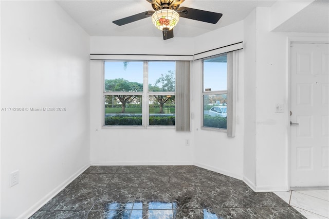 unfurnished room with ceiling fan, a textured ceiling, and a wealth of natural light