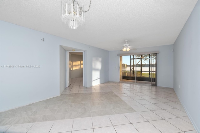 tiled spare room with ceiling fan with notable chandelier and a textured ceiling