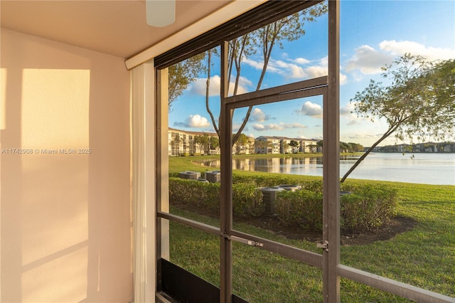 unfurnished sunroom with a water view