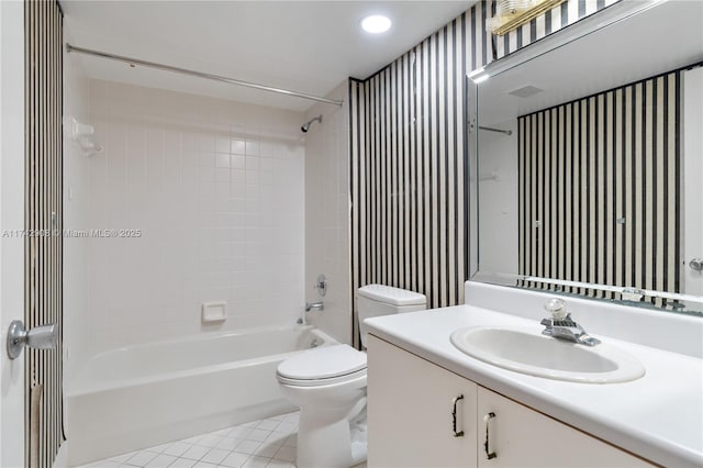 full bathroom with vanity, tiled shower / bath combo, tile patterned floors, and toilet