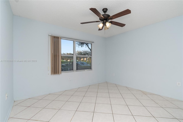 spare room with a textured ceiling and ceiling fan