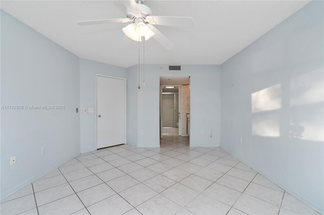 unfurnished room featuring ceiling fan and light tile patterned floors