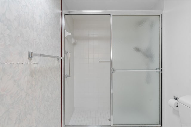 bathroom featuring an enclosed shower and toilet