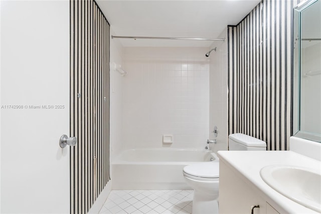 full bathroom with tiled shower / bath, vanity, toilet, and tile patterned flooring