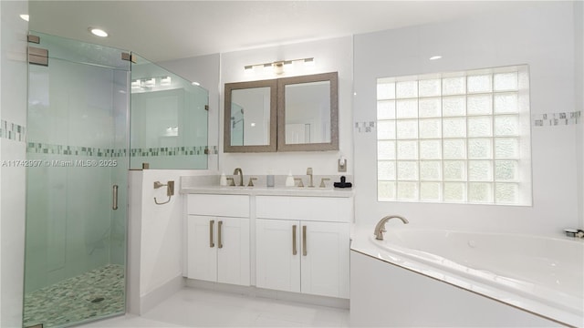 bathroom featuring shower with separate bathtub and vanity