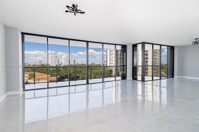 unfurnished room with expansive windows