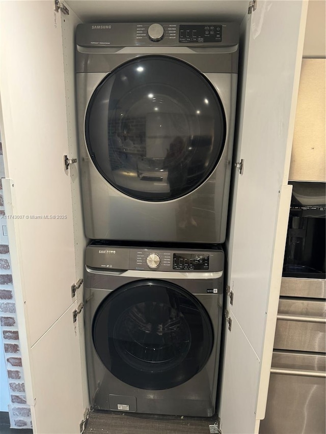 laundry area with stacked washer and clothes dryer