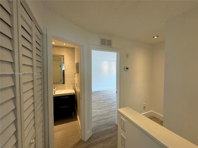 hallway with light hardwood / wood-style floors