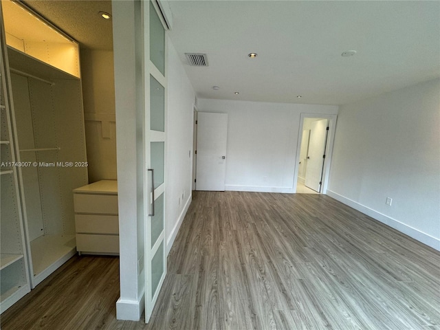 unfurnished bedroom featuring hardwood / wood-style flooring