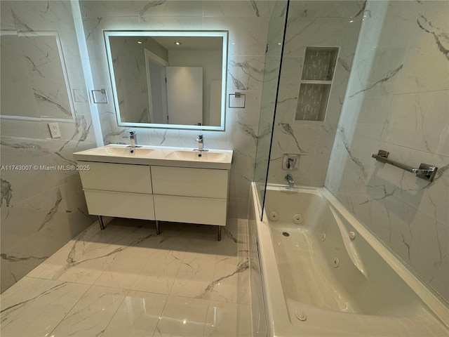 bathroom featuring tiled shower / bath combo, vanity, and tile walls