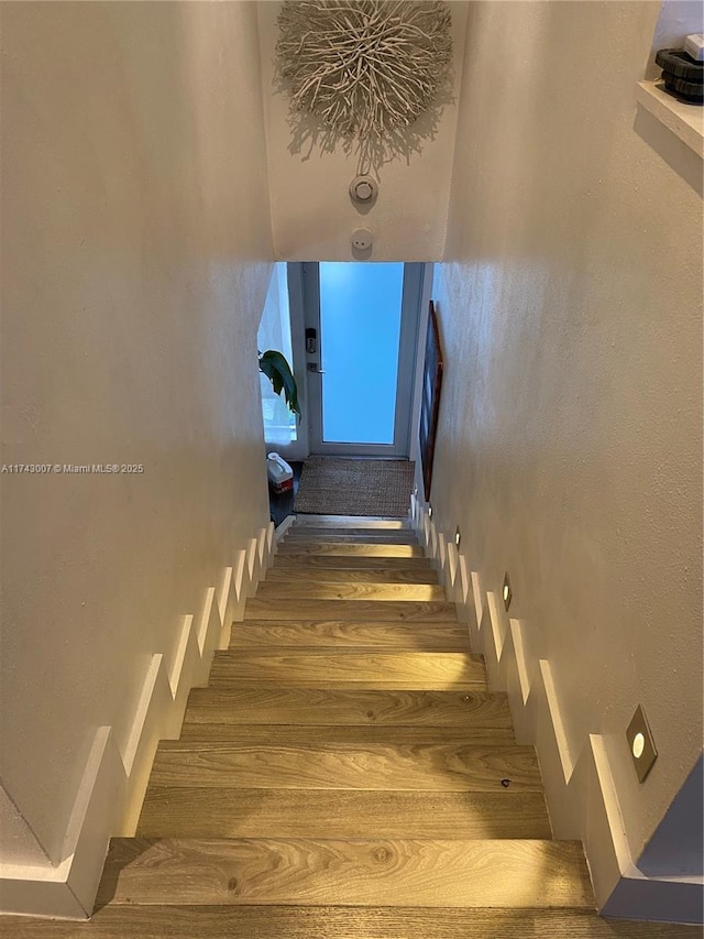 stairs featuring wood-type flooring