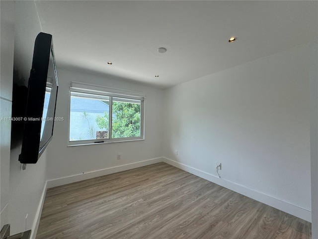 spare room with light hardwood / wood-style floors