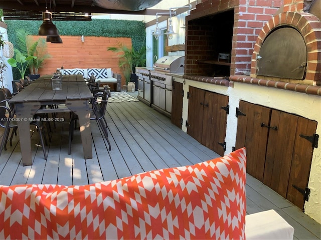 wooden deck featuring area for grilling and exterior kitchen