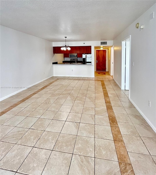 unfurnished living room with light tile patterned floors, a textured ceiling, and a chandelier