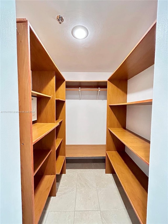 walk in closet with tile patterned flooring