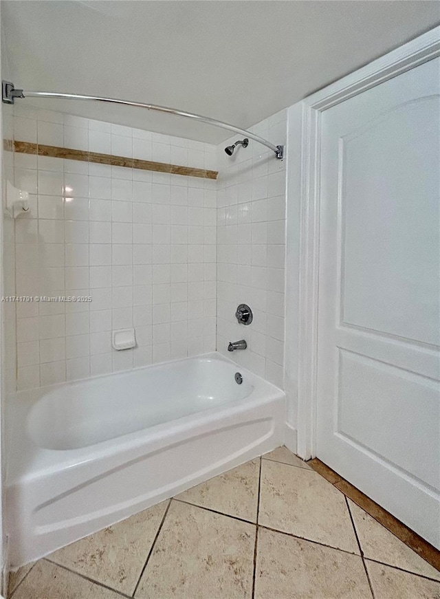 bathroom with tile patterned flooring and tiled shower / bath