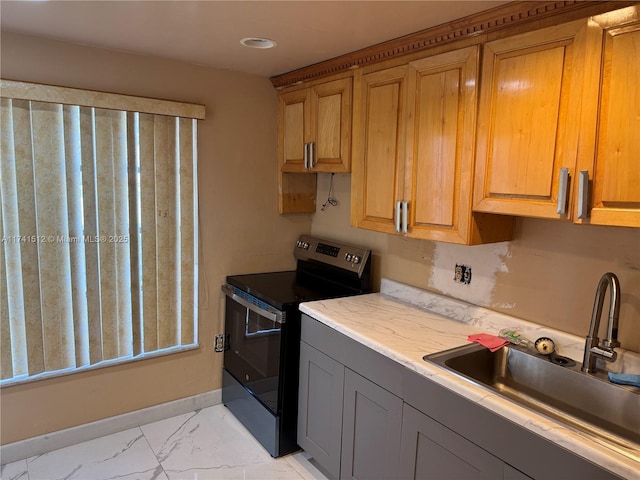 kitchen featuring electric range oven, gray cabinets, and sink