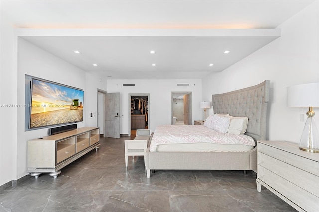 bedroom featuring a walk in closet and a closet